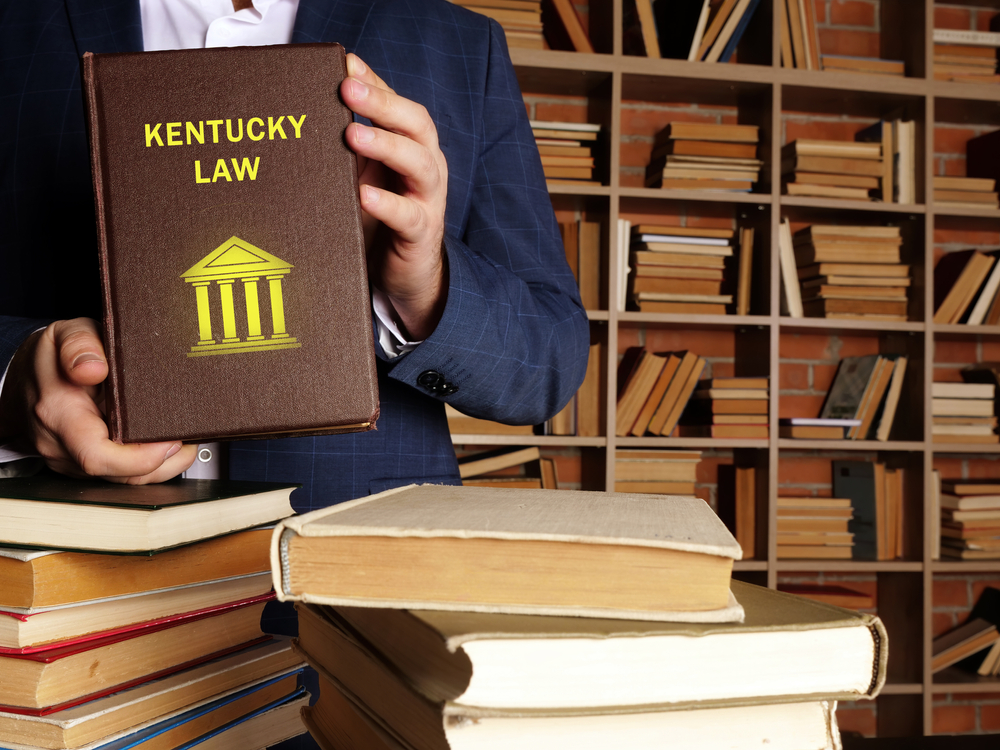 KENTUCKY LAW book in the hands of a attorney. Kentucky residents are subject to Kentucky state and U.S. federal laws
